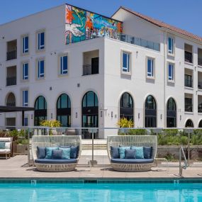 Camden Hillcrest Apartments San Diego CA pool with daybeds and arch windows and mural in the background