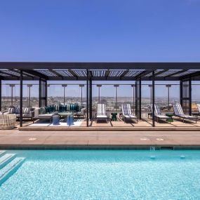 Camden Hillcrest Apartments San Diego CA expansive pool and loungers under a cabana with views of Mission Valley