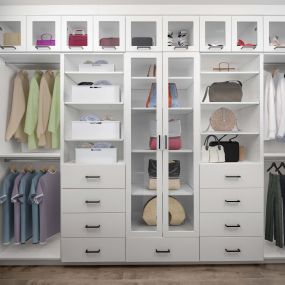 Camden Hillcrest apartments San Diego CA custom closet with built-in shelves, drawers, and glass front cabinets