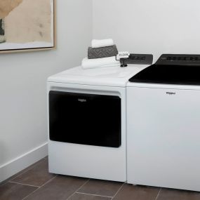 Full size washer and dryer in large laundry room