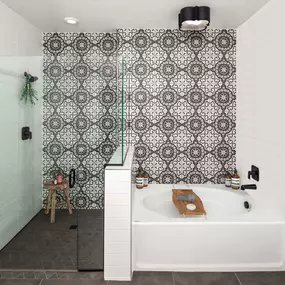 Camden Hillcrest apartments san diego ca five fixture main bathroom with italian inspired tiled accent wall and glass enclosed shower near soaking tub under designer lighting