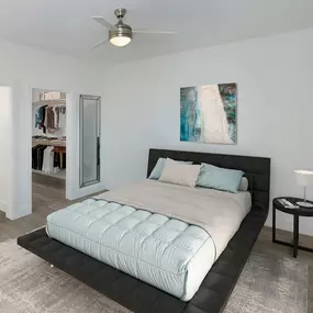 Main bedroom with ceiling fan, walk-in closet, ensuite bathroom and wood flooring