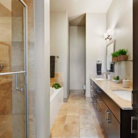 Townhome bathroom with stand up shower bathtub and tile flooring