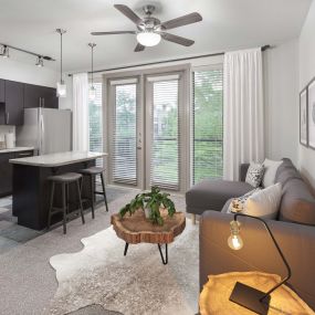 Soft loft style floor plan living room and kitchen with private balcony at Camden Belmont apartments in Dallas, TX