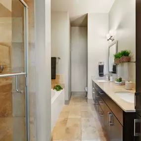 Townhome bathroom with stand up shower bathtub and tile flooring