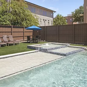 Tanning ledge with turf yard seating at Camden Belmont apartments in Dallas, TX