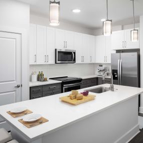 Desert modern style kitchen island with barstool seating and pantry and stainless steel appliances