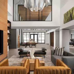 Double height resident lounge with fireplace and seating