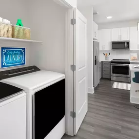 Desert modern style laundry room with full size washer and dryer alongside kitchen