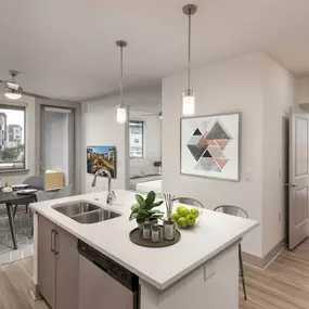 Contemporary style open concept studio kitchen island with white quartz countertops and barstool seating