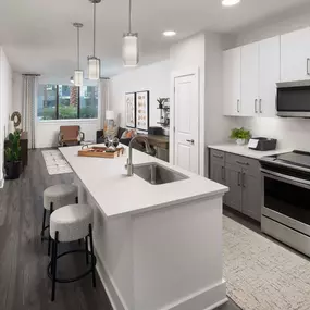 Desert modern style kitchen island with barstool seating and stainless steel appliances gray vein quartz counters