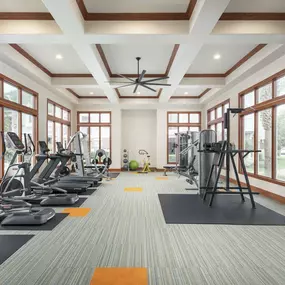 Fitness center with cardio equipment and free weights at Camden Grand Harbor Apartments in Katy, TX
