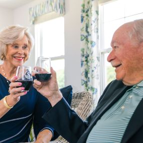 Two residents having a glass of wine