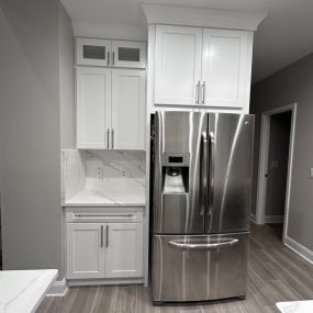 All white kitchen with new flooring and appliances.