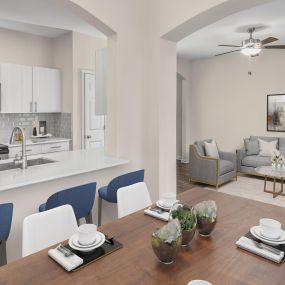Dining room and kitchen with arched entryway into living room at Camden Governors Village Apartments in Chapel Hill, NC