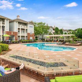 Firepit and seating area alongside pool at Camden Governors Village Apartments in Chapel Hill, NC