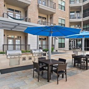 Pool deck covered tables and bbq grills at Camden Lamar Heights