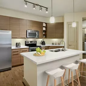 Kitchen and laundry with island white quartz countertops and stainless steel appliances