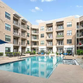 Resort-style pool with in-water loungers at Camden Lamar Heights