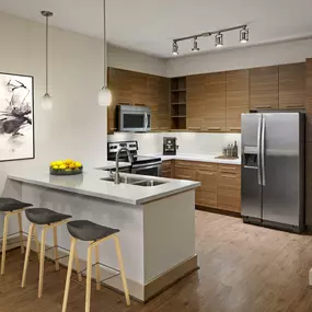 Two bedroom kitchen with white quartz countertops and stainless steel appliances