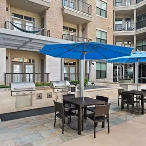 Pool deck covered tables and bbq grills at Camden Lamar Heights