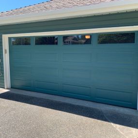 Home with a new blue garage door