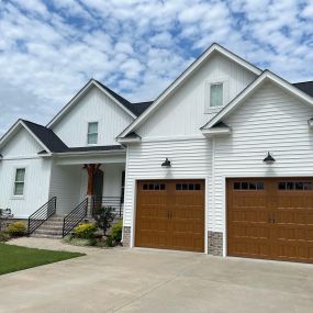 white home with brown garage doors