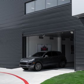 Modern home with a car coming out of the garage door
