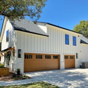 white home with a brown garage