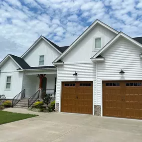 white home with brown garage doors