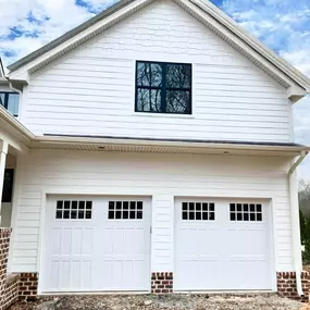 White home with double garage doors