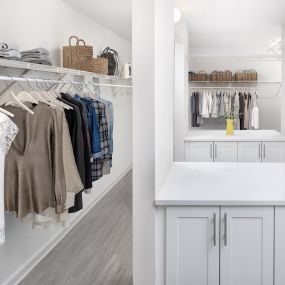 Expansive walk-in closet with built-in cabinets and shelving