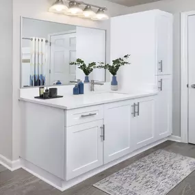 Modern style bathroom with quartz countertops and bathtub with tile surround and curved shower rod