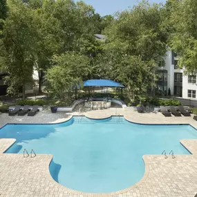 Resort style pool with outdoor cooking and dining area at Camden Phipps in Atlanta, GA