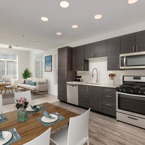 Modern kitchen with white quartz countertops, stainless steel appliances, wood-style flooring, and warm brown cabinetry