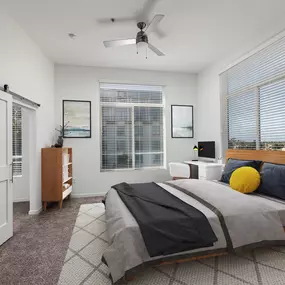 Bedroom with ceiling fan and barn door