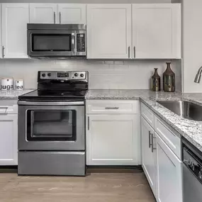 Kitchen with stainless steel appliances and quartz countertops