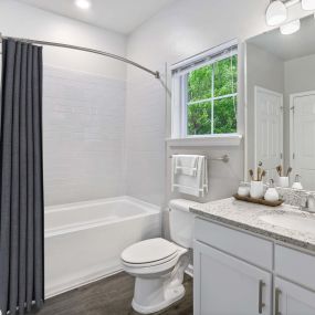 Contemporary style bathroom with window and curved shower rod