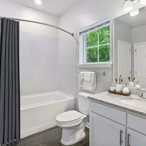 Contemporary style bathroom with window and curved shower rod