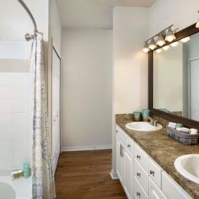 Bathroom with double sink vanity and large soaking bathtub