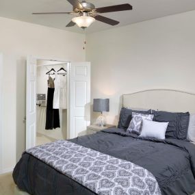 Spacious bedroom with ceiling fan and walk-in closet