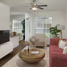 Living room with large windows and ceiling fan at Camden Lago Vista apartments in Orlando, FL