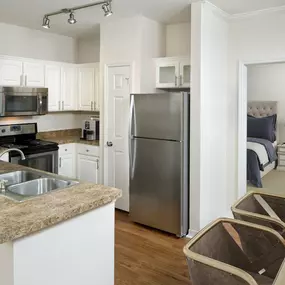 Kitchen with stainless steel appliances and large pantry at Camden Lago Vista apartments in Orlando, FL