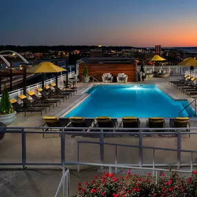 Dusk view of rooftop swimming pool and entertainment lounge