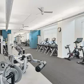 24-hour fitness center with cardio and strength training equipment