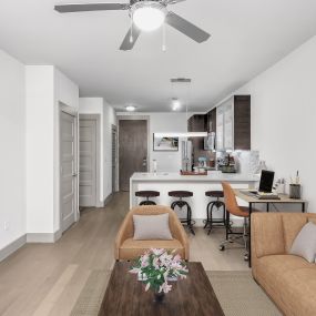 Open-concept living, dining, and kitchen area with work from home space at Camden Gallery Apartments in Charlotte, NC