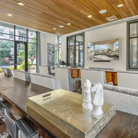 Resident lounge with seating and television overlooking saltwater pool