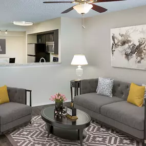 Living room with ceiling fan and wood inspired flooring