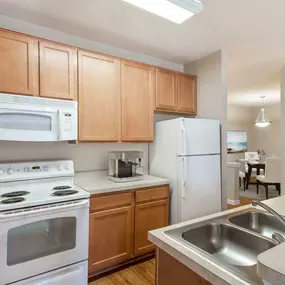 Traditional-style kitchen with Laminate Countertops and White Appliances