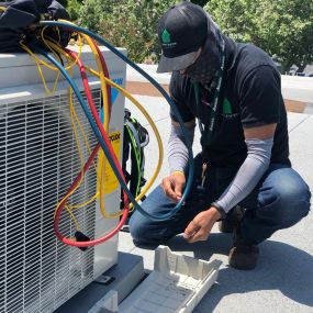 Meet our HVAC specialists in action! This photo showcases the expertise and precision that go into servicing and diagnosing HVAC units